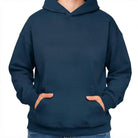 Schlichter Kapuzenpullover in zeitlosem Dunkelblau bzw. French Navy Blue ohne Sign mit den Händen in der Kängurutasche.