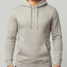 Pastellfarbener Herren-Hoodie in hellem Natural Raw ohne Sign vor weißem Hintergrund.